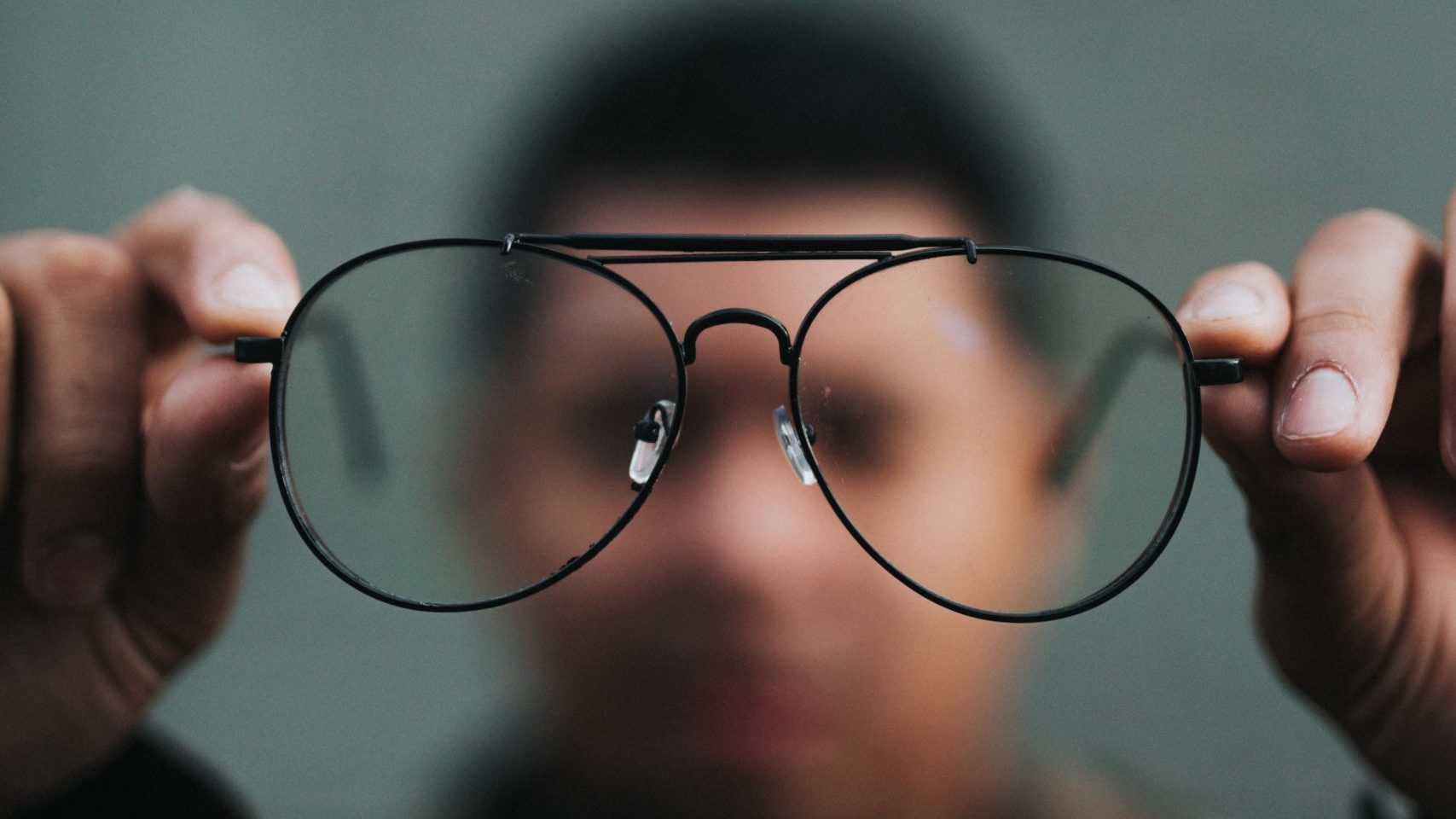 man holding glasses